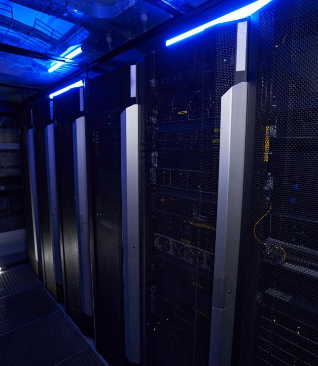 Close up image of data center with multiple rows of fully operational server racks